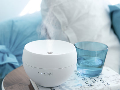 Stadler Form Jasmine aroma diffuser in white in a bed room
